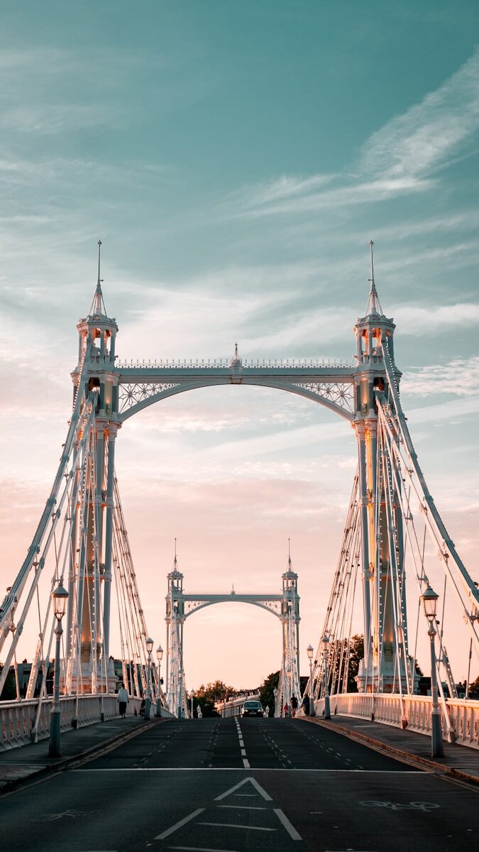 A large bridge spanning over a street with a sky background